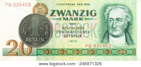 1 Mark Coin Against Historic 20 East German Mark Bank Note