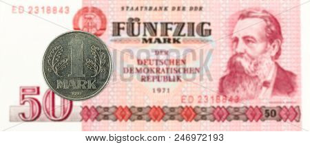 1 Mark Coin Against Historic 50 East German Mark Bank Note