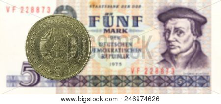 5 Mark Coin Against Historic 5 East German Mark Bank Note