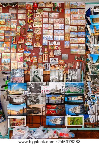 LUCCA, ITALY - MAY 31, 2018: Street stall with fridge magnets  souvenirs and postcards for sale