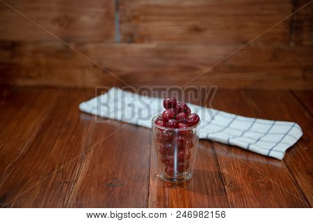 Sweet Cherry, Black Cherries In A Glass On Wooden Background.