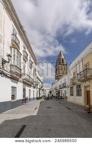 Medina Sidonia, Cadiz, Spain, July, 2017: A Street With The Church Tower In The Background Of Medina