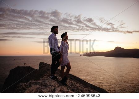 Romantic Summer Love Story On A Sunset In Mountains. Young Girl And Boy In Love.