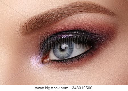Beautiful Closeup Eye Make-up With Purple Glitter Shadows. Fashion Celebrate Makeup, Clean Skin, Per