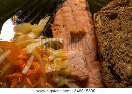 Dinner, Pickled Cabbage And Carrots In Red Fish Salmon And Cereal Brown Bread On A Plate With A Fork