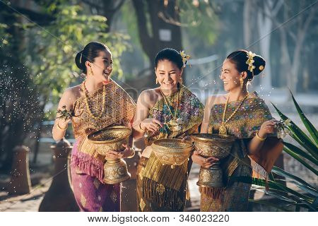 Beautiful Asian Woman Splashing Water During Tradition Festival Thai,songkran Festival.