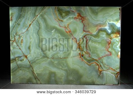 A Large Slab Of Natural Green Stone With Red Veins Is Called Verde Onix