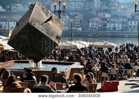 Oporto, Portugal- December 30, 2020: People Enjoying Drinks In A Bar Terrace On The Banks Of The Dou