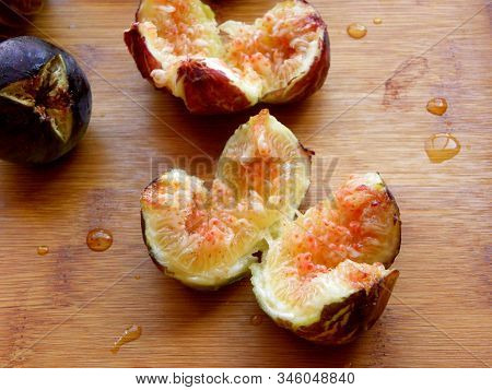 Figs Cut On A Wooden Table Close-up