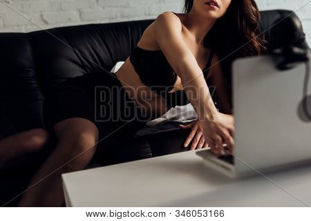 Cropped View Of Attractive Girl In Bra Using Laptop With Web Camera On Sofa, Selective Focus