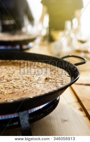 Paella Pan With Traditional Spanish Food Usually Prepared With Rice, Meat, Seafood. Vertical Orienta