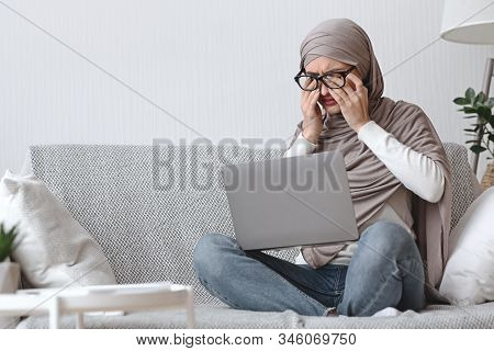 Eye Strain. Tired Muslim Woman In Hijab Having Eyesight Problem, Massaging Nosebridge After Working 