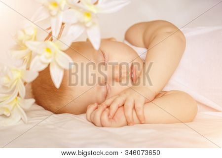 Sleeping baby. Cute kid sleeping on bed in bedroom. ?hild sleeps and sees a dream.