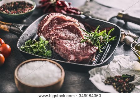 Beef Ribe Eye Steak In Grill Pan With Rosemary Oregano Salt Pepper Spices Garlic And Tomatoes