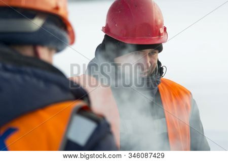 Slinger In An Orange Helmet At The Installation Site
