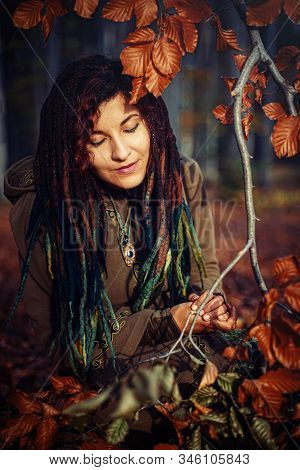 Beautiful Girl With Radiant Red Hair In Sommer Dress In A Meditative Spiritual Gesture Of Prayer.