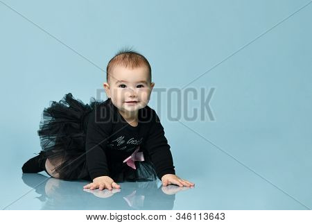 Little Babe In Black Bodysuit With Pink Bow, Poofy Skirt And Socks. She Smiling, Creeping On Floor A