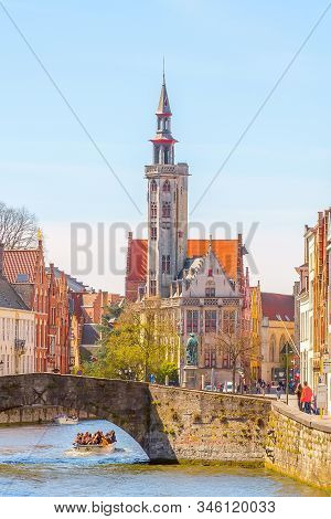 Bruges, Belgium - April 10, 2016: Panorama With Canal, Jan Van Eyck Square And Tolhuis Tower
