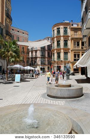 Malaga, Spain - July 11, 2008 - Fountains And Pavement Cafes In The City Plaza With People Enjoying 