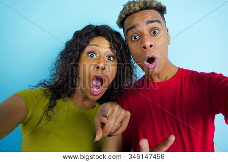 Pointing In Camera While Selfie. Young Emotional African-american Man And Woman In Colorful Clothes 