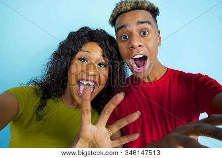 Pointing In Camera While Selfie. Young Emotional African-american Man And Woman In Colorful Clothes 