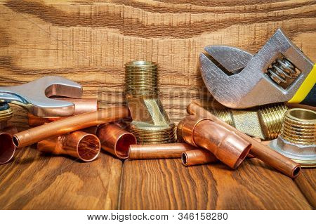 Spare Parts With Copper And Brass Accessories For Plumbing Repair On Vintage Wooden Boards