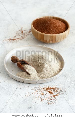 Teff Flour On A Plate With A Spoon And Teff Grain In A Bowl  Close Up