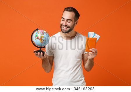 Smiling Young Man In Casual White T-shirt Posing Isolated On Orange Wall Background Studio Portrait.