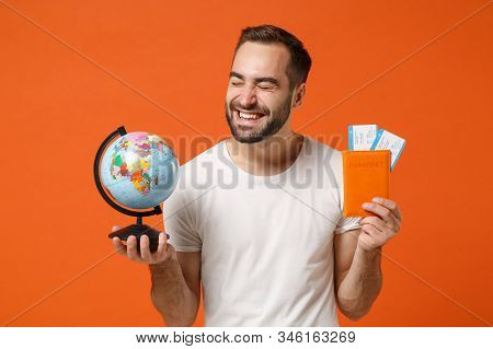 Happy Young Man In Casual White T-shirt Posing Isolated On Orange Wall Background. People Lifestyle 