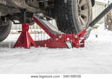 Hydraulic Trolley Jack Car Lift And Jack Stand For Changing Car Wheels. Replacing Wheel In Winter On
