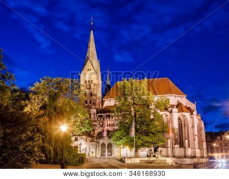 Romanesque Augsburg Cathedral (Augsburger Dom), one of the city's main attractions, illuminated at night. Augsburg, Swabia, Bavaria, Germany