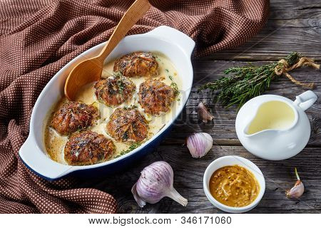 Rabbit Ballotine In A Creamy Mustard Sauce With Herbs And Spices In A Baking Dish  With Spoon On A R