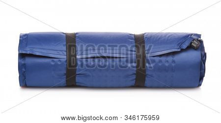 Front view of rolled blue self-inflating foam camping mattress isolated on white