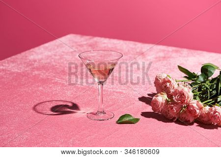 Rose Wine In Glass Near Bouquet Of Roses On Velour Pink Cloth Isolated On Pink, Girlish Concept