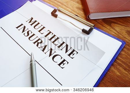 Multiline Insurance Agreement And Pile Of Papers.