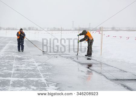 Installers In Life Jackets Rafting Ice Panels To The Lane With The Beograms