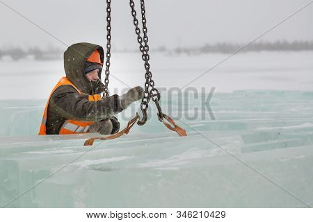 Slinger In Orange Helmet On Shipment Of Ice Blocks