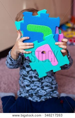 Little Boy Collects The Puzzle Sitting On Floor. Big Abc Squishy Foam Puzzle. Learning Alphabet With