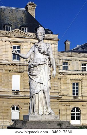 Statue Of Goddess Minerva With An Owl In Her Hand, In Front Of The Luxembourg Palace. Paris/ France