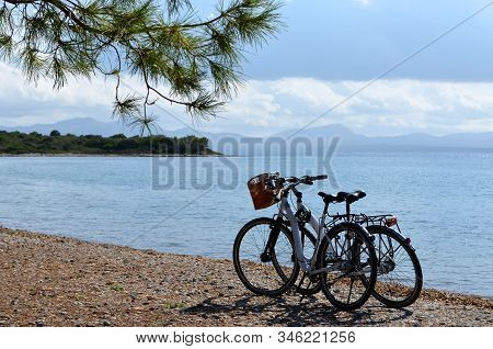 Alcudia / Mallorca - Spain; 10/11/2013: Two Bikes On The Beach Of Aucanada. Sky With Clouds Above Th