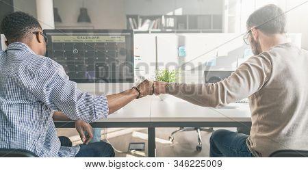 First Bump Between Colleagues At Work. Success In Business. Everyday Work In The Office.