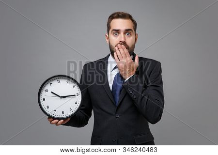 Shocked Young Bearded Business Man In Classic Suit Shirt Tie Posing Isolated On Grey Background. Ach