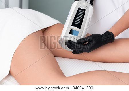 Cosmetologist In Rubber Gloves Doing Endospheres Therapy On Female Hips
