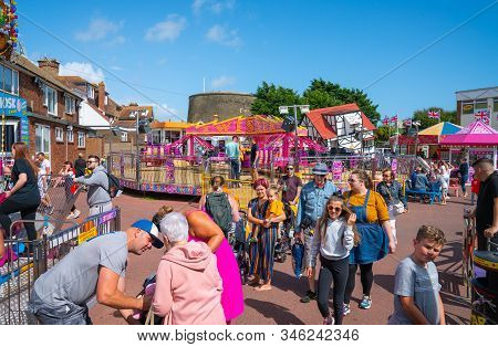 Dymchurch England - August 19 2019; Amusement Park Full Of People And Families Moving Between Attrac