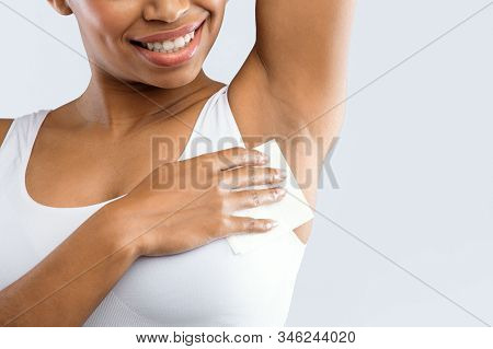 Close Up Of Afro Woman Wiping Her Under Arms With Nepkin, Hyperhidrosis Concept