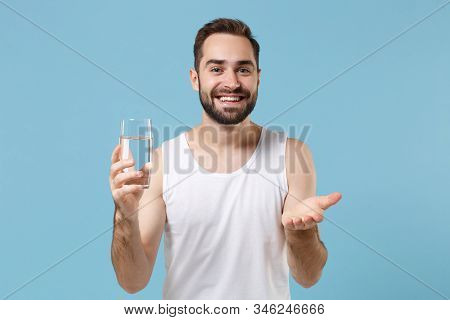 Bearded Young Man 20s Years Old Perfect Skin In White Shirt Hold Water Isolated On Blue Pastel Wall 