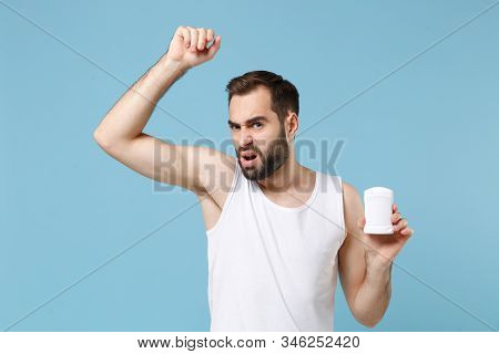 Bearded Young Man 20s Years Old In White Shirt Hold Using Antiperspirant Isolated On Blue Pastel Wal