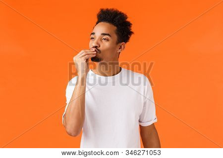 Magnifico. Impressed And Delighted African-american Guy With Moustache And Afro Haircut, Kissing Fin