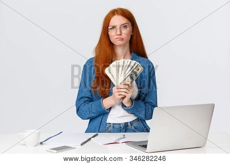 Thoughtful And Hesitant Serious-looking Redhead Female Got Payed, Won Big Money Prize In Online Art 