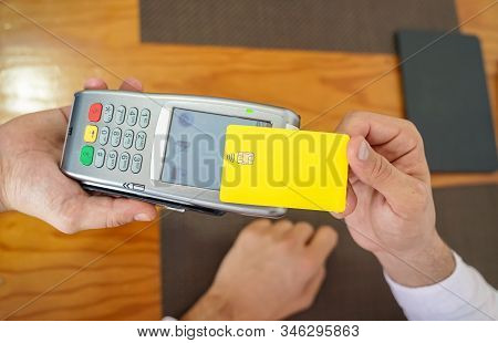Male Customer Paying With Contactless Credit Card With Nfc Technology - Waiter With A Credit Card Re